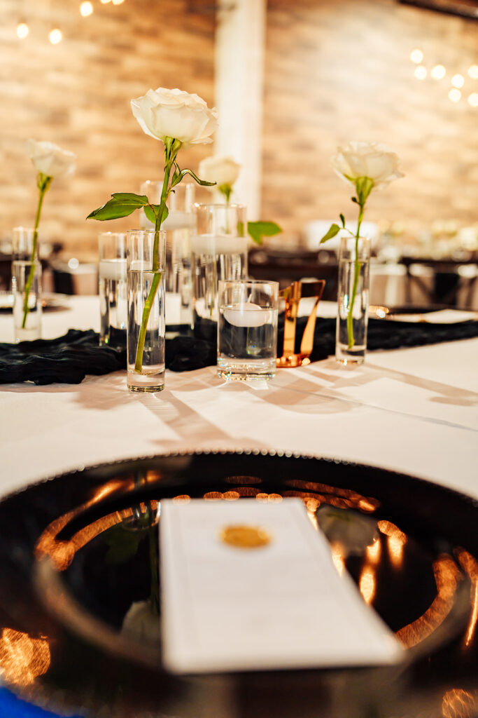 Elegantly decorated tables with floral arrangements and candlelight at Gentry Pines reception