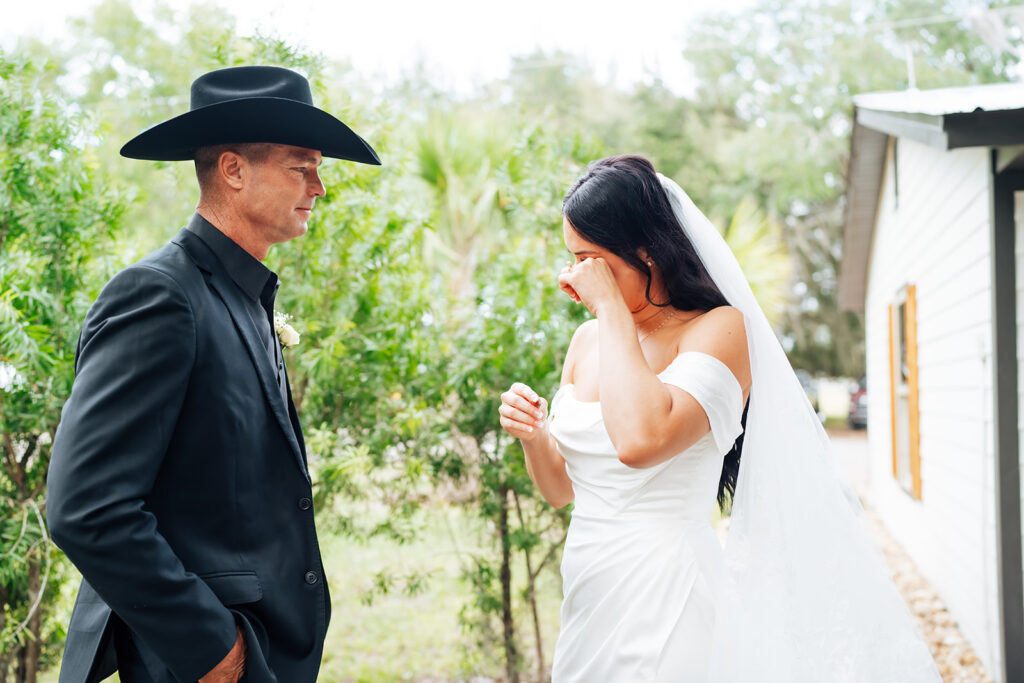 Bride and father sharing an emotional first look at Gentry Pines.