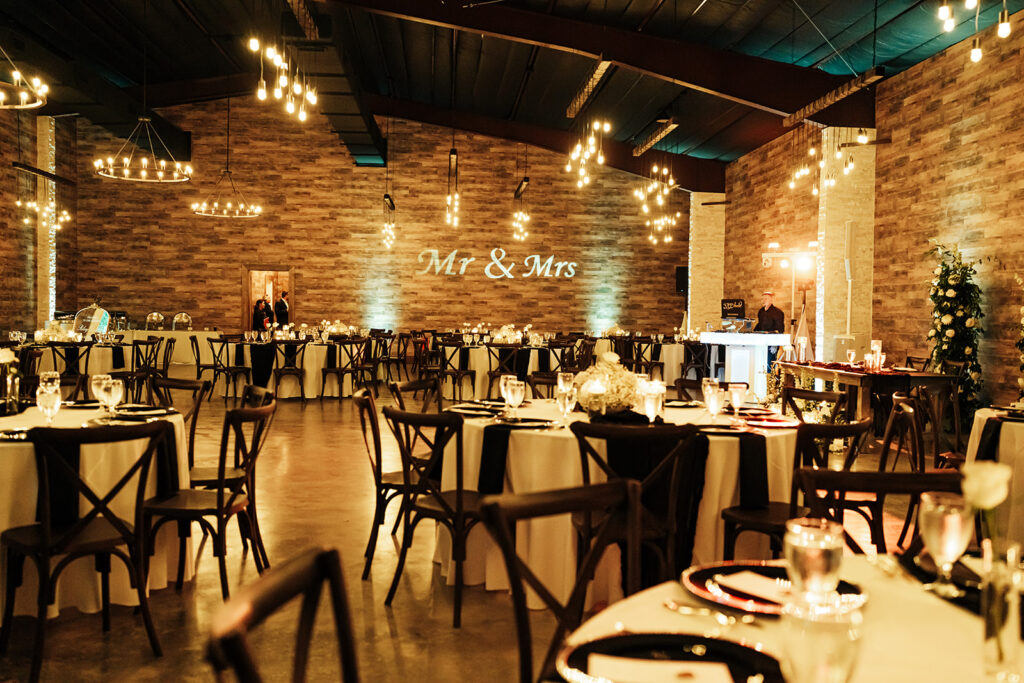 Elegantly decorated tables with floral arrangements and candlelight at Gentry Pines reception