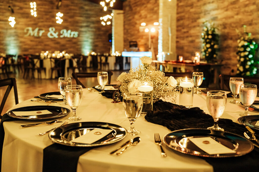 Elegantly decorated tables with floral arrangements and candlelight at Gentry Pines reception