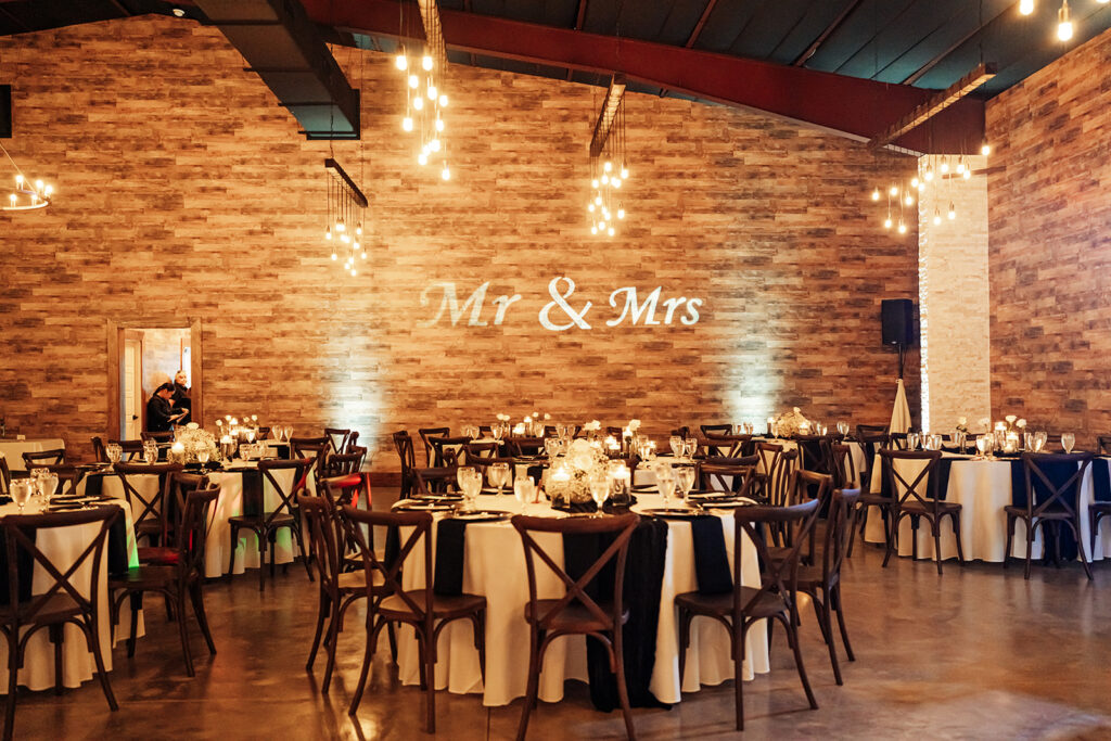 Elegantly decorated tables with floral arrangements and candlelight at Gentry Pines reception