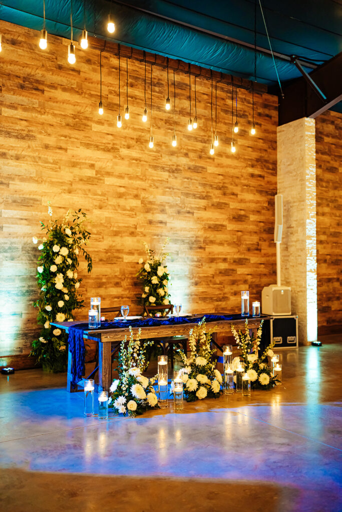 Elegantly decorated tables with floral arrangements and candlelight at Gentry Pines reception