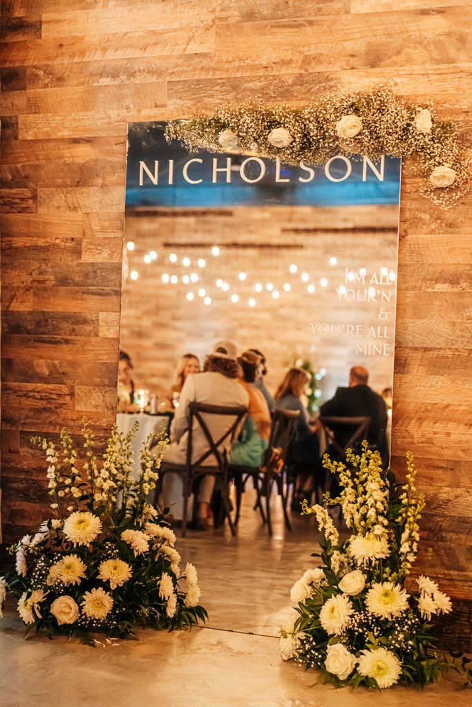 Elegantly decorated tables with floral arrangements and candlelight at Gentry Pines reception