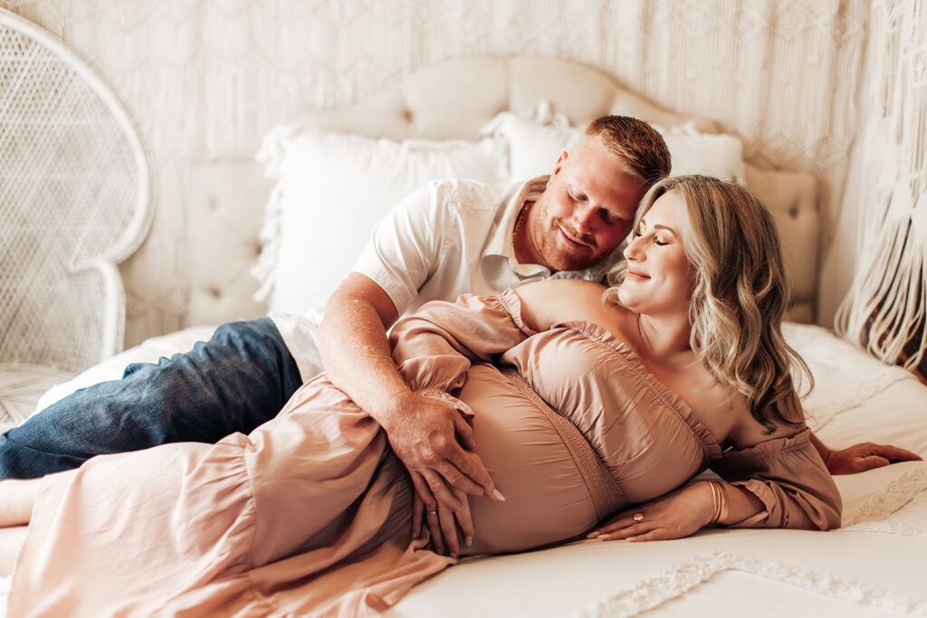 Expectant mother smiling during a studio maternity photoshoot at Wings of Glory Photography