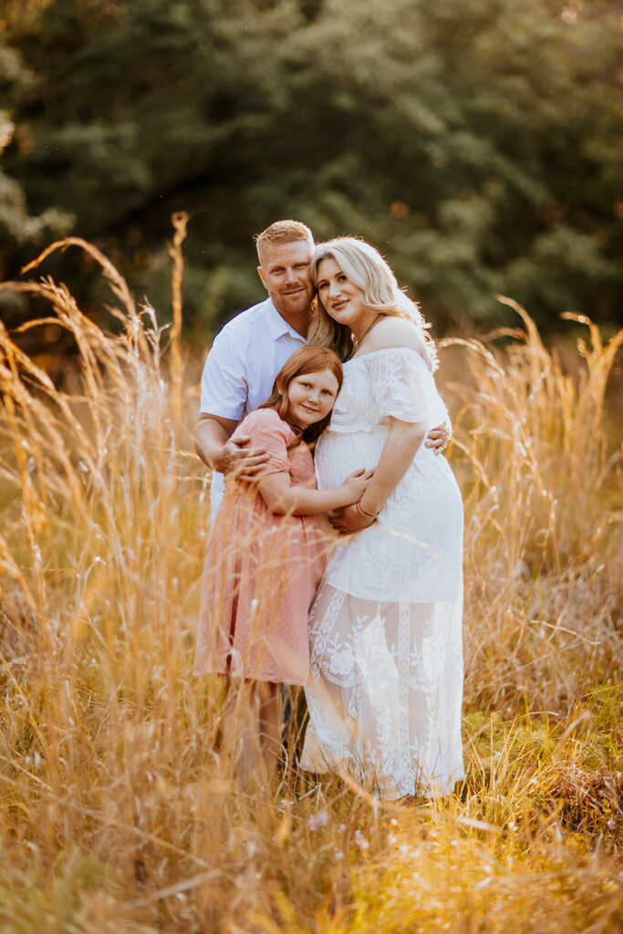 Pregnant couple walking hand in hand through a picturesque outdoor location during a maternity photoshoot with Wings of Glory Photography