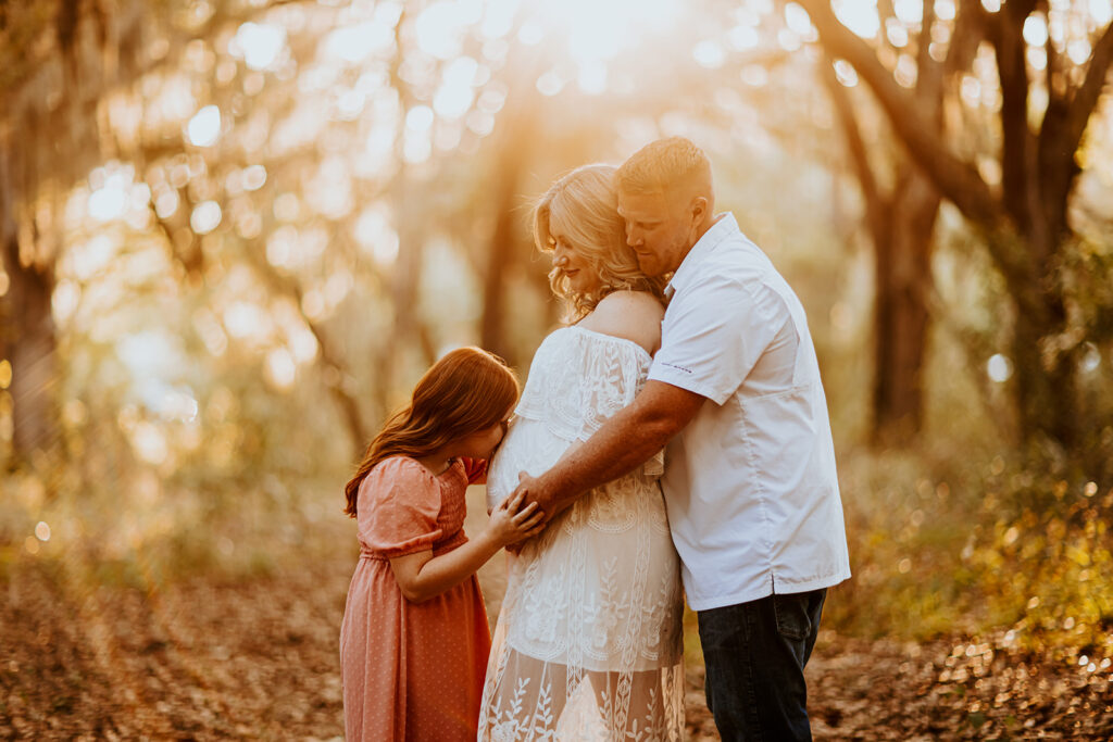 Pregnant couple walking hand in hand through a picturesque outdoor location during a maternity photoshoot with Wings of Glory Photography