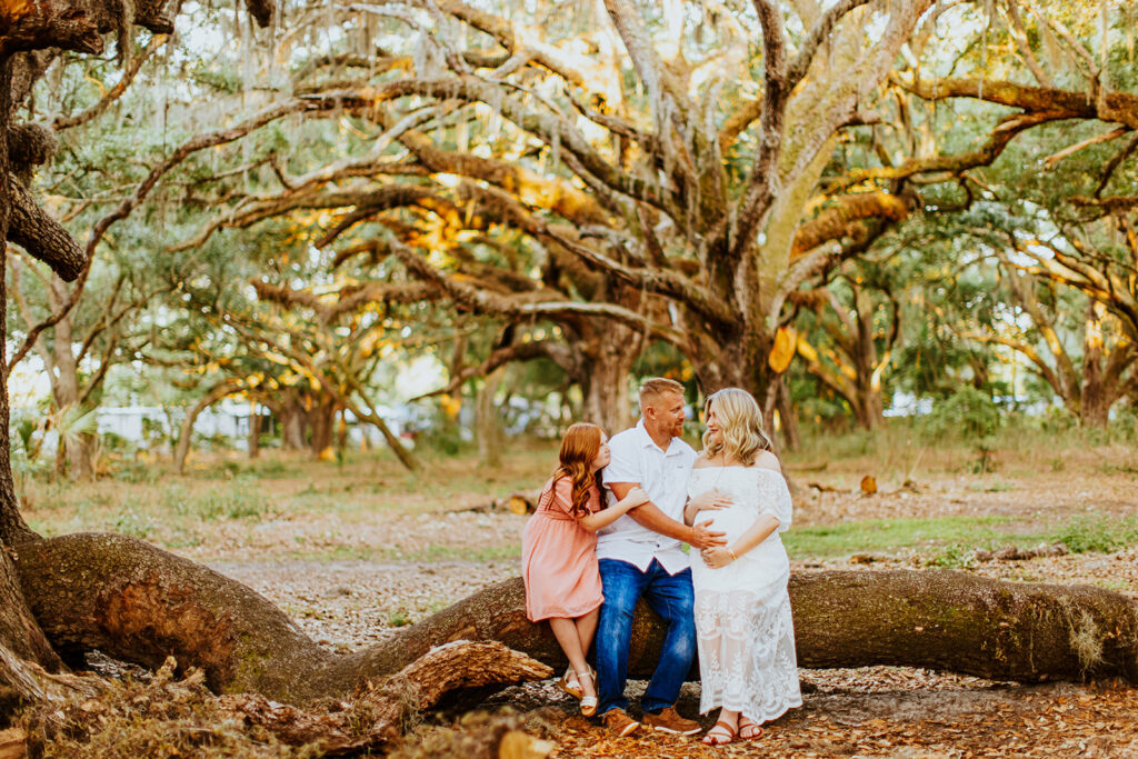 Pregnant couple walking hand in hand through a picturesque outdoor location during a maternity photoshoot with Wings of Glory Photography