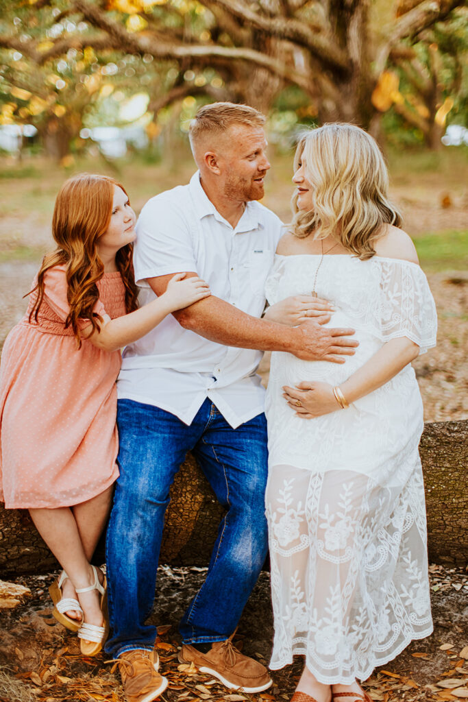 Pregnant couple walking hand in hand through a picturesque outdoor location during a maternity photoshoot with Wings of Glory Photography