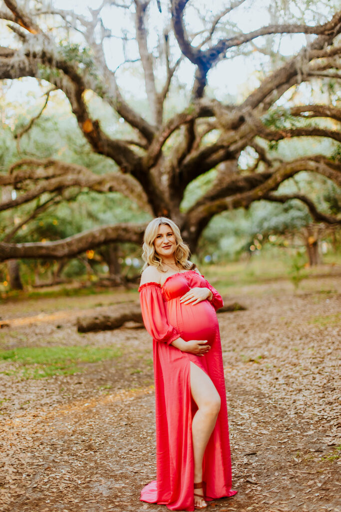 Pregnant couple walking hand in hand through a picturesque outdoor location during a maternity photoshoot with Wings of Glory Photography